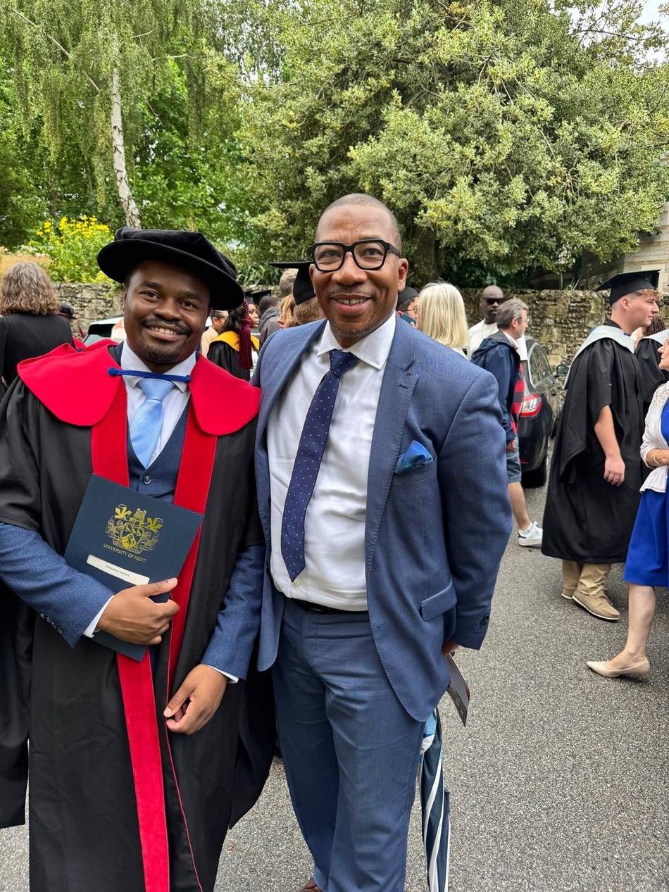 David Villa-Clarke with Dr Emmanuel Molefi at his University of Kent doctoral graduation